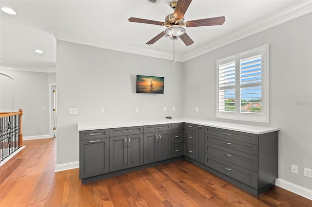 1171 Red Maple Cir NE, Saint Petersburg, FL 33703 - kitchen featuring gray cabinets, crown molding, ceiling fan, wood-type flooring, and light countertops
