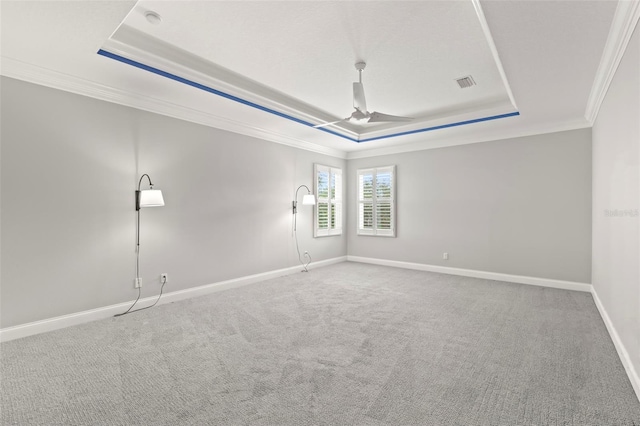 1171 Red Maple Cir NE, Saint Petersburg, FL 33703 - spare room featuring a tray ceiling, ornamental molding, carpet, baseboards, and a ceiling fan