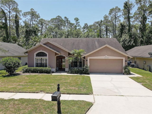 3338 Laurelwood Ct, Tarpon Springs, FL 34688 - ranch-style house featuring a garage, a front yard, stucco siding, driveway, and central AC unit
