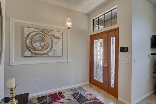 3338 Laurelwood Ct, Tarpon Springs, FL 34688 - entrance foyer featuring a textured ceiling, baseboards, and wood finished floors