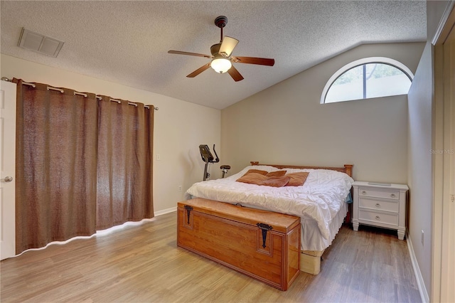 3338 Laurelwood Ct, Tarpon Springs, FL 34688 - bedroom with lofted ceiling, light wood-type flooring, a textured ceiling, ceiling fan, and baseboards