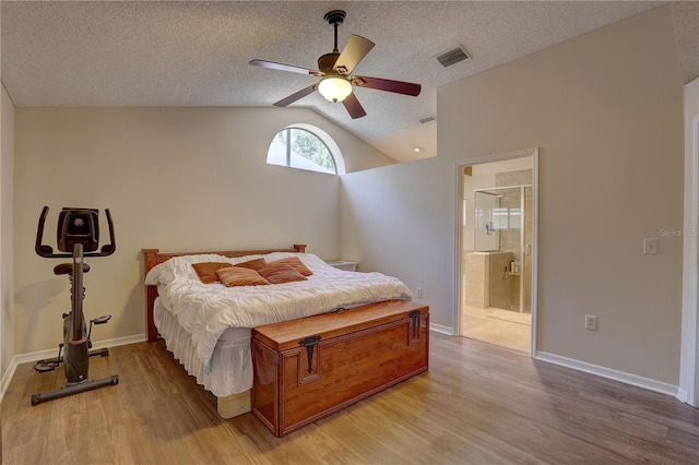3338 Laurelwood Ct, Tarpon Springs, FL 34688 - bedroom with light wood-style floors, lofted ceiling, ensuite bath, baseboards, and ceiling fan