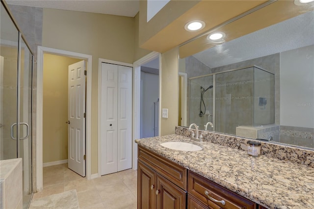 3338 Laurelwood Ct, Tarpon Springs, FL 34688 - bathroom featuring a stall shower, vanity, tile patterned flooring, a closet, and baseboards