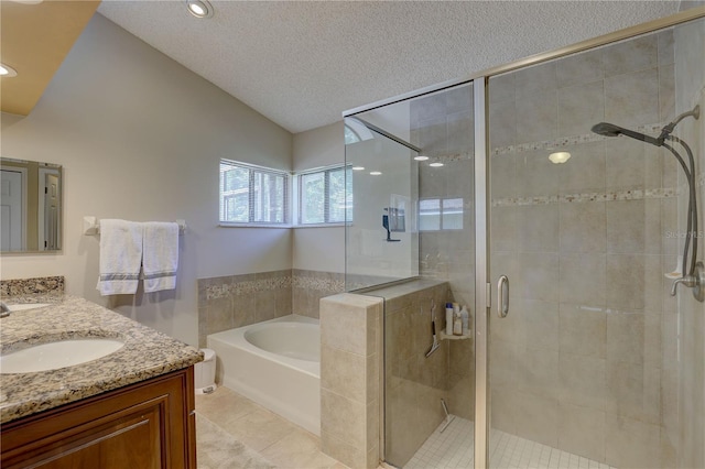 3338 Laurelwood Ct, Tarpon Springs, FL 34688 - full bath with vaulted ceiling, a garden tub, a shower stall, double vanity, and a textured ceiling