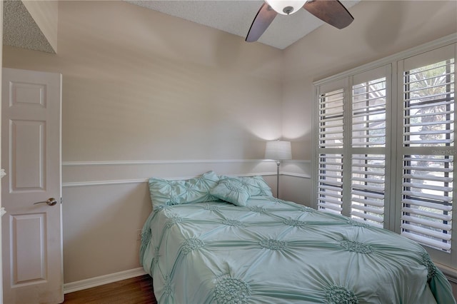 3338 Laurelwood Ct, Tarpon Springs, FL 34688 - bedroom featuring multiple windows, baseboards, wood finished floors, and ceiling fan