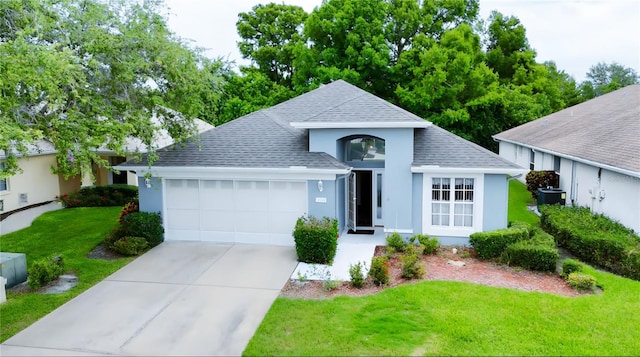 14116 Whitecap Ave, Hudson, FL 34667 - ranch-style house featuring roof with shingles, a garage, a front yard, concrete driveway, and stucco siding