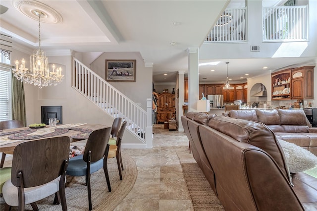 dining room featuring stairway, a chandelier, baseboards, light stone finish flooring, and crown molding