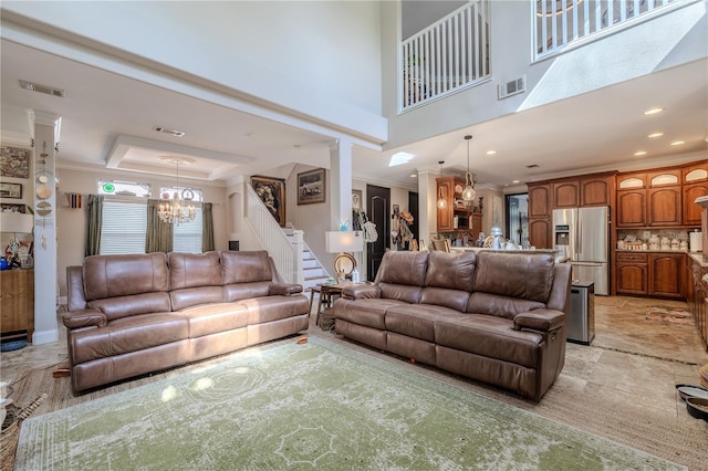 living area featuring a chandelier, stairs, crown molding, recessed lighting, and a high ceiling