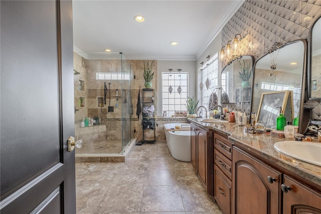 bathroom with ornamental molding, a shower stall, a freestanding bath, double vanity, and recessed lighting