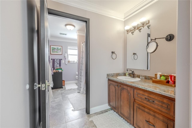 bathroom featuring crown molding, toilet, vanity, baseboards, and tile patterned flooring