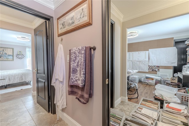 bathroom featuring crown molding, baseboards, and tile patterned flooring
