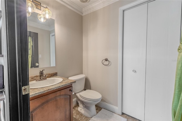 bathroom with vanity, toilet, crown molding, and baseboards