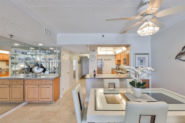 13720 Gulf Blvd Unit 302, Madeira Beach, FL 33708 - dining room with crown molding, ceiling fan, light tile patterned floors, a textured ceiling, and baseboards