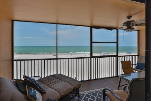 13720 Gulf Blvd Unit 302, Madeira Beach, FL 33708 - sunroom featuring a ceiling fan and view of water and beach