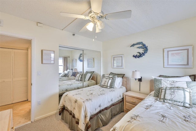 13720 Gulf Blvd Unit 302, Madeira Beach, FL 33708 - bedroom with carpet, a closet, a ceiling fan, baseboards, and a textured ceiling