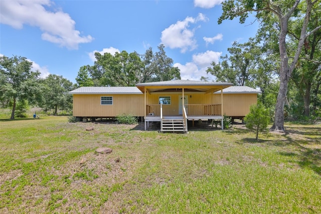 2112 33rd St SE, Ruskin, FL 33570 - rear view of house with a yard and a wooden deck