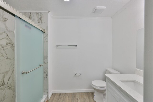 2112 33rd St SE, Ruskin, FL 33570 - bathroom with ornamental molding, vanity, a marble finish shower, toilet, and wood finished floors