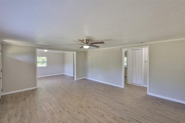 2112 33rd St SE, Ruskin, FL 33570 - empty room with a ceiling fan, wood finished floors, a textured ceiling, crown molding, and baseboards
