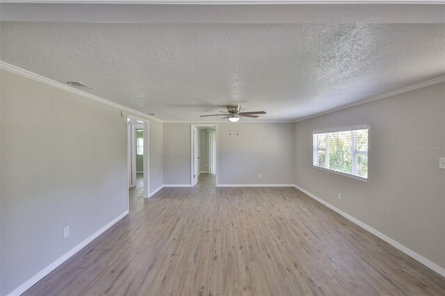 2112 33rd St SE, Ruskin, FL 33570 - spare room featuring ceiling fan, ornamental molding, wood finished floors, baseboards, and a textured ceiling