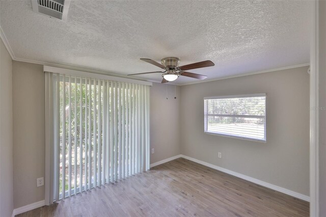 2112 33rd St SE, Ruskin, FL 33570 - empty room with a ceiling fan, wood finished floors, baseboards, a textured ceiling, and ornamental molding