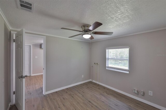 2112 33rd St SE, Ruskin, FL 33570 - unfurnished room with wood finished floors, a textured ceiling, a ceiling fan, crown molding, and baseboards