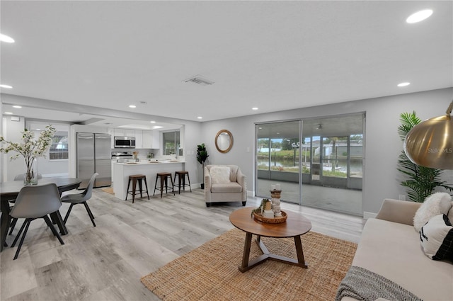 6914 Harbor Dr, Hudson, FL 34667 - living room with recessed lighting, light wood-type flooring, and baseboards