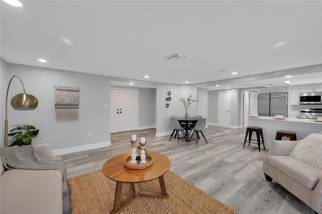 6914 Harbor Dr, Hudson, FL 34667 - living room with recessed lighting, baseboards, and light wood-style floors