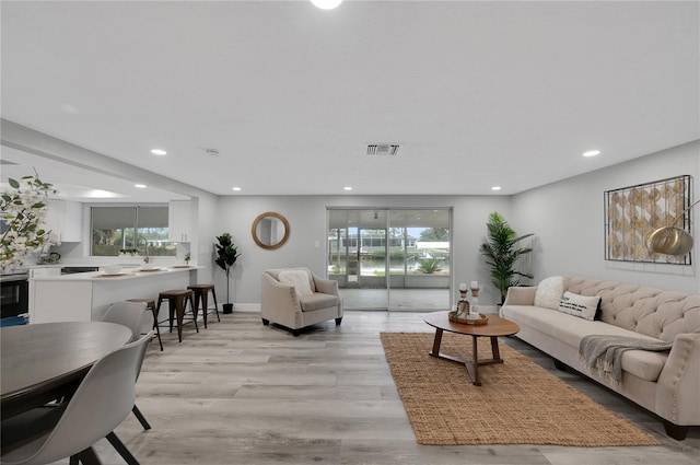 6914 Harbor Dr, Hudson, FL 34667 - living area with recessed lighting, light wood-style floors, and baseboards