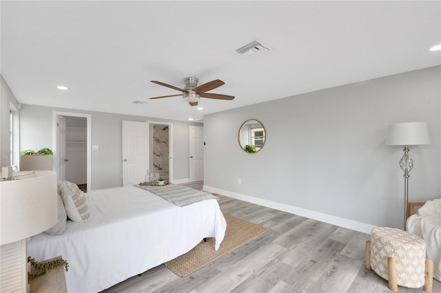 6914 Harbor Dr, Hudson, FL 34667 - bedroom featuring light wood-style flooring, recessed lighting, baseboards, ceiling fan, and a walk in closet