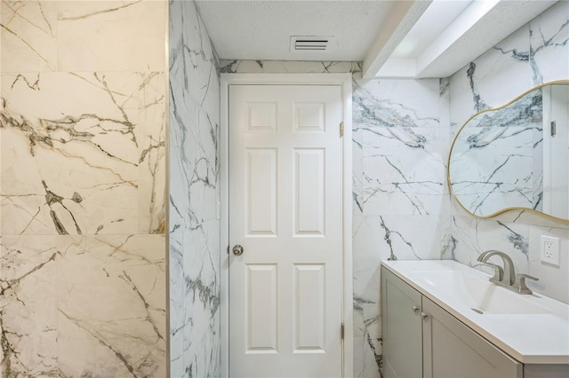 6914 Harbor Dr, Hudson, FL 34667 - bathroom featuring vanity and tile walls