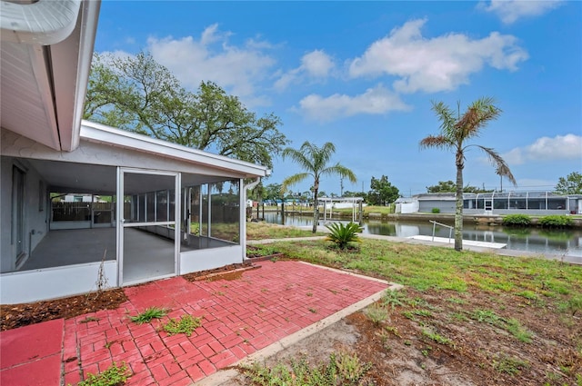 6914 Harbor Dr, Hudson, FL 34667 - view of yard featuring a sunroom, a water view, a patio, and a dock