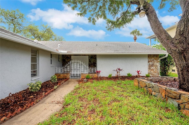 6914 Harbor Dr, Hudson, FL 34667 - property entrance featuring stucco siding, stone siding, and roof with shingles