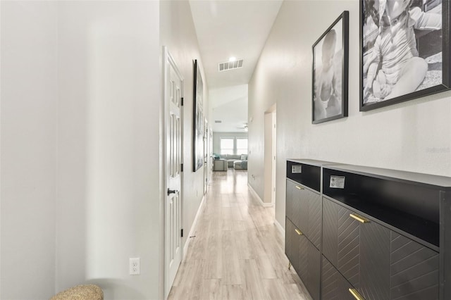 hallway with baseboards and light wood-style flooring
