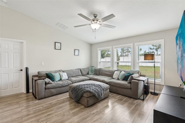 living area featuring vaulted ceiling, light wood-type flooring, ceiling fan, and baseboards