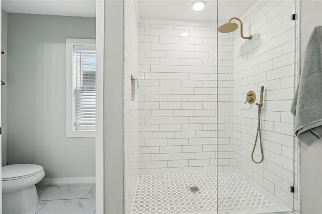 bathroom with a shower stall, marble finish floors, toilet, and baseboards