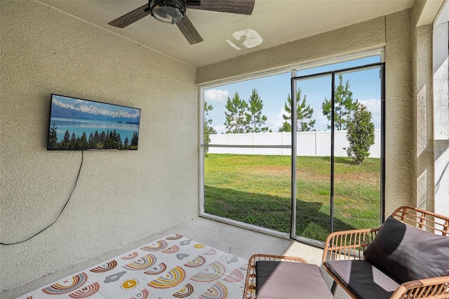 sunroom with a ceiling fan