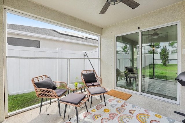 sunroom / solarium featuring a ceiling fan
