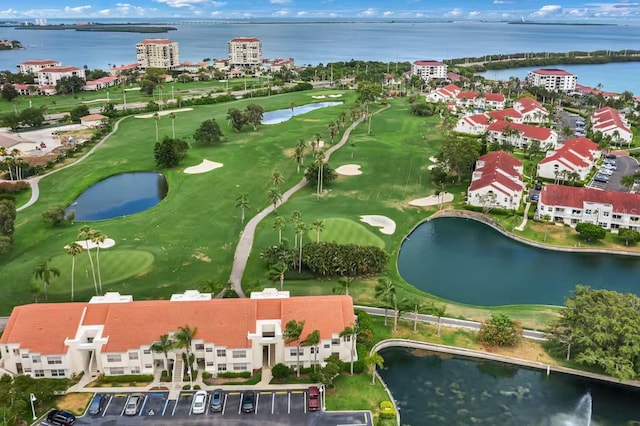 aerial view of property's location with a large body of water and a local golf course
