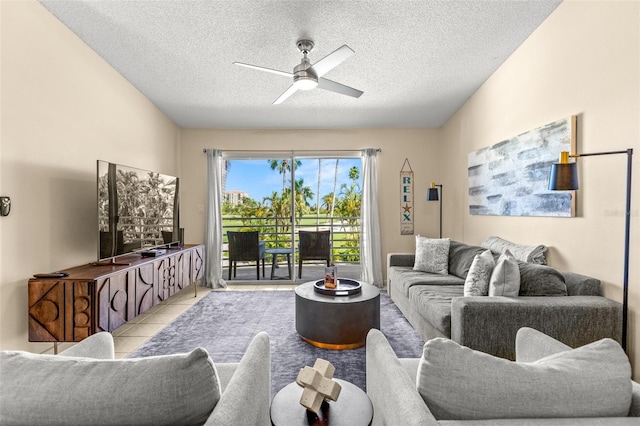 living area featuring a textured ceiling, a ceiling fan, and light tile patterned floors