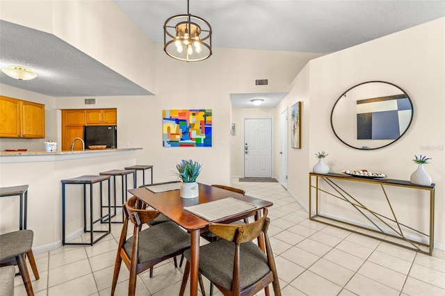dining room featuring light tile patterned flooring, a chandelier, and baseboards