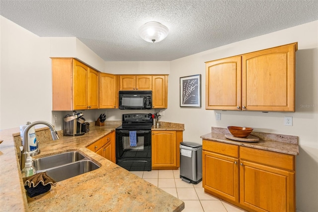 kitchen featuring black appliances, a sink, a textured ceiling, light tile patterned floors, and light stone counters