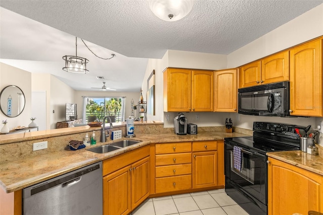 kitchen with black appliances, a sink, a peninsula, light stone counters, and ceiling fan
