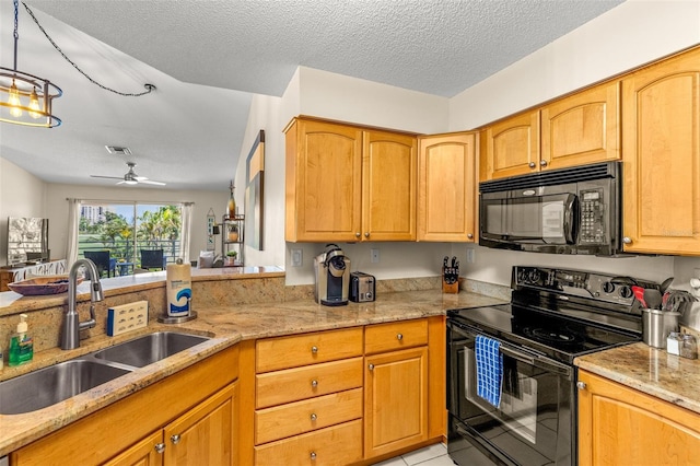 kitchen featuring black appliances, a sink, light stone counters, a ceiling fan, and a textured ceiling