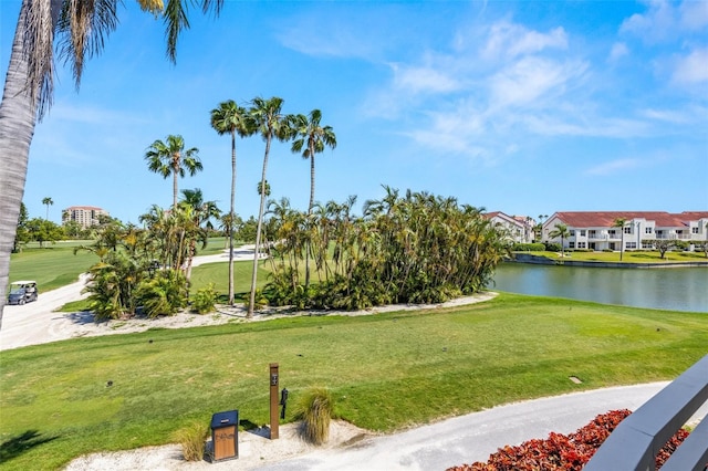 surrounding community featuring a water view, golf course view, and a lawn