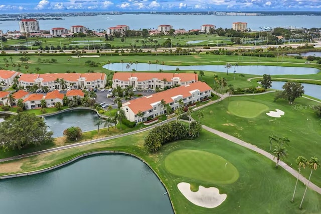 aerial view of property and surrounding area featuring a large body of water and a local golf course