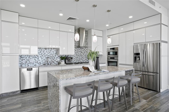 199 Dali Blvd Unit 2, Saint Petersburg, FL 33701 - kitchen with stainless steel appliances, modern cabinets, wall chimney range hood, a sink, and white cabinetry