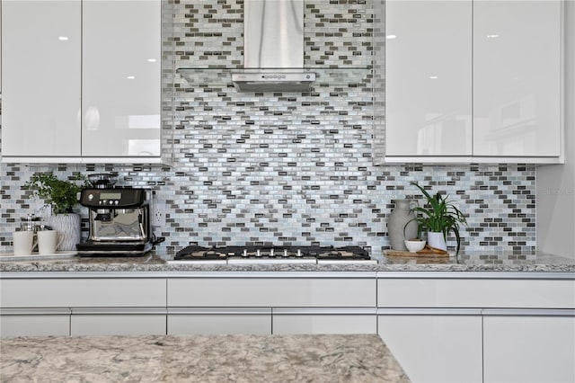 199 Dali Blvd Unit 2, Saint Petersburg, FL 33701 - kitchen with tasteful backsplash, white cabinetry, stainless steel gas cooktop, light stone counters, and modern cabinets