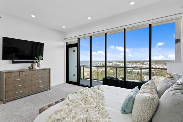 199 Dali Blvd Unit 2, Saint Petersburg, FL 33701 - bedroom with light carpet, access to exterior, recessed lighting, baseboards, and multiple windows