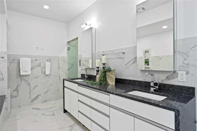 199 Dali Blvd Unit 2, Saint Petersburg, FL 33701 - bathroom with tile walls, wainscoting, marble finish floors, double vanity, and recessed lighting