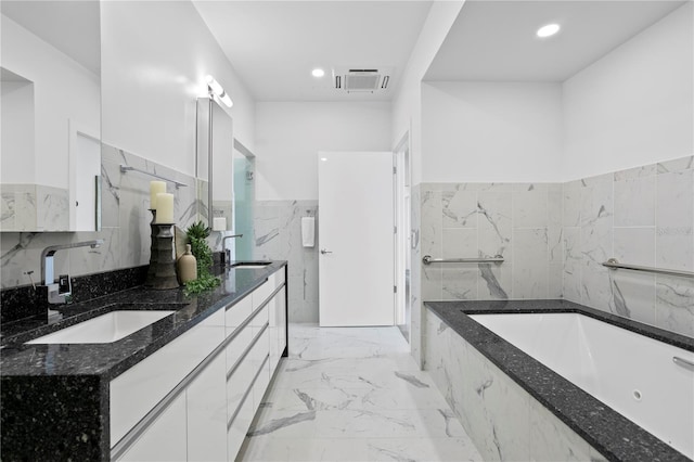 199 Dali Blvd Unit 2, Saint Petersburg, FL 33701 - full bath with tile walls, marble tiled floors, a tub with jets, double vanity, and wainscoting